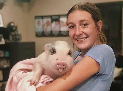 PHS student holding a pig