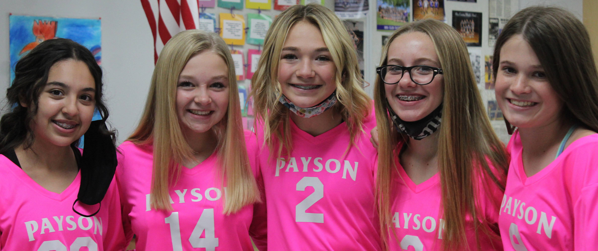 5 female students in matching pink shirts